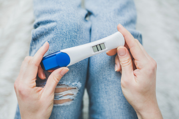 woman-looking-positive-pregancy-test_1220-3946