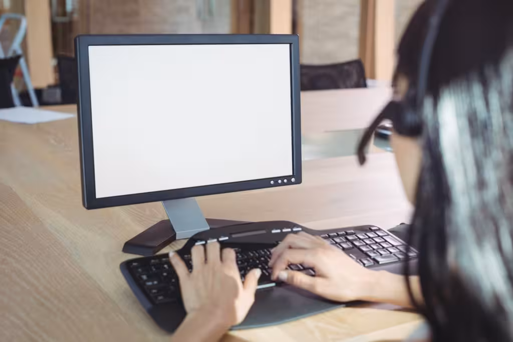 Cropped image of businesswoman working on computer at call center