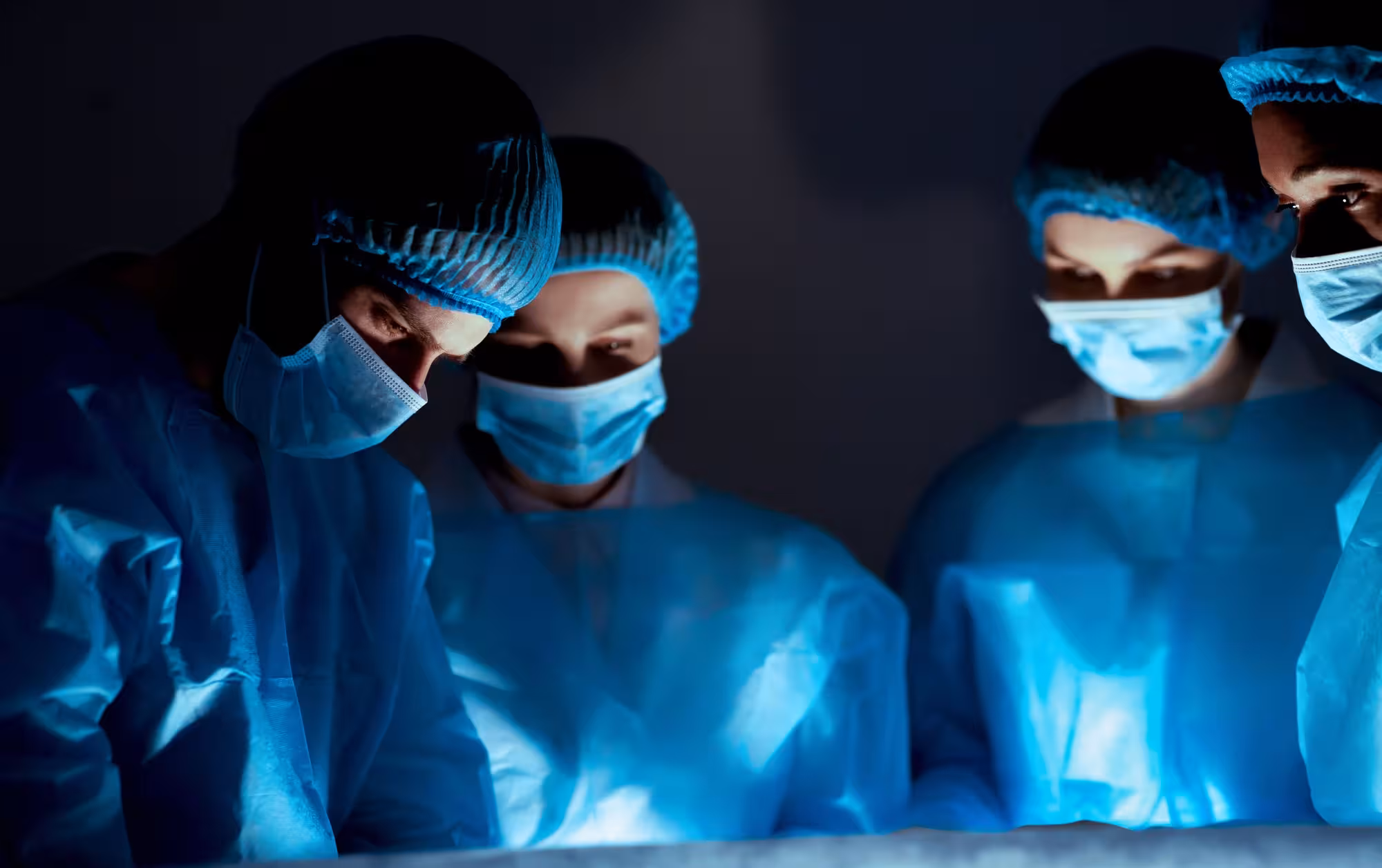 Team of professional surgeons performing surgery in hospital