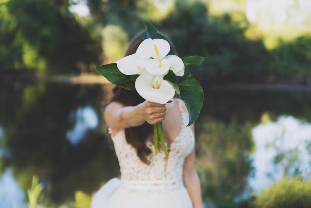Young beautiful bride holding a bouquet.